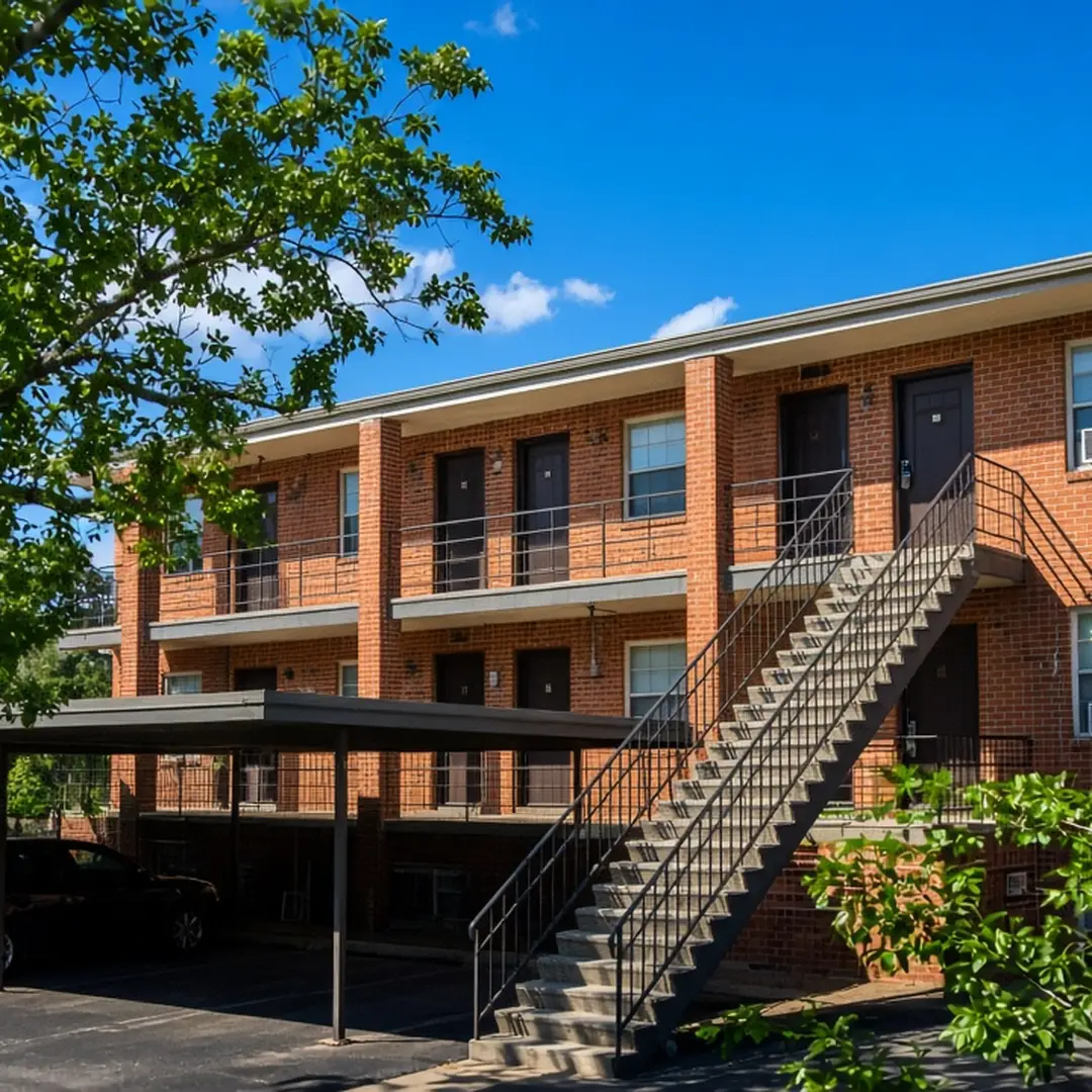 Two-story brick apartment building with exterior stairs in Fort Worth